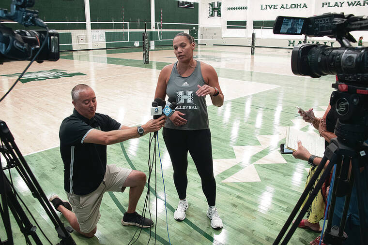 CRAIG T. KOJIMA / CKOJIMA@STARADVERTISER.COM 
                                UH head coach Robyn Ah Mow conducted interviews on Tuesday. Holding up the microphones was UH assistant media relations director Neal Iwamoto.