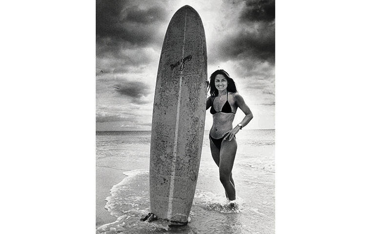 STAR-ADVERTISER / 1983
                                Rell Sunn was seen with her board on the shore.