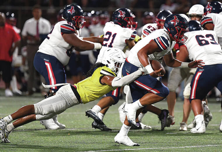 STEVEN ERLER / SPECIAL TO THE STAR-ADVERTISER
                                Saint Louis quarterback Oha Kamakawiwo’ole was chased down and tackled by Mililani Trojans linebacker Kamaehu Roman.