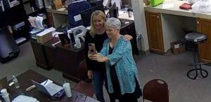 COFFEE COUNTY, GEORGIA VIA ASSOCIATED PRESS
                                In this Jan. 7, 2021, image, Cathy Latham (right) appears to take a selfie with a member of a computer forensics team inside the local elections office. Latham was the county Republican Party chair at the time. The computer forensics team was at the county elections office in Douglas, Ga., to make copies of voting equipment in an effort that documents show was arranged by Sidney Powell and others allied with then-President Donald Trump.