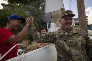 ASSOCIATED PRESS / SEPT. 21
                                A National Guardsman greets a neighbor after delivering water to the residents of Punta Diamante in Ponce, Puerto Rico, Wednesday, Sept. 21.