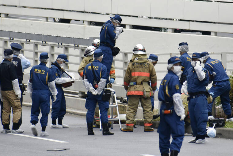 KYODO NEWS / AP
                                Police and firefighters inspect the scene where a man is reported to set himself on fire, near the Prime Minister’s Office in Tokyo, Wednesday, Sept. 21. The man was taken to a hospital Wednesday, in an apparent protest against a planned state funeral next week for the assassinated former leader Shinzo Abe, officials and media reports said.