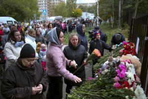 ASSOCIATED PRESS
                                People gather to lay flowers, put toys and light candles in memory of victims of the shooting at school No. 88 in Izhevsk, Russia, today. Authorities say a gunman has killed 17 people and wounded 24 others in a school in central Russia.