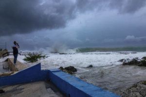 ASSOCIATED PRESS / SEPT. 26
                                A woman takes photos while waves crash against a seawall as Hurricane Ian passes through George Town, Grand Cayman island, Sept. 26.