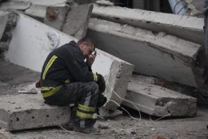 ASSOCIATED PRESS
                                A rescue worker takes a pause as he sits on the debris at the scene where a woman was found dead after a Russian attack that heavily damaged a school in Mykolaivka, Ukraine, today.