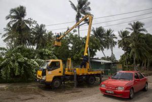 ASSOCIATED PRESS
                                An electric company worker remove tree branches felled on power lines in the wake of Hurricane Ian in Havana, Cuba, on Wednesday.