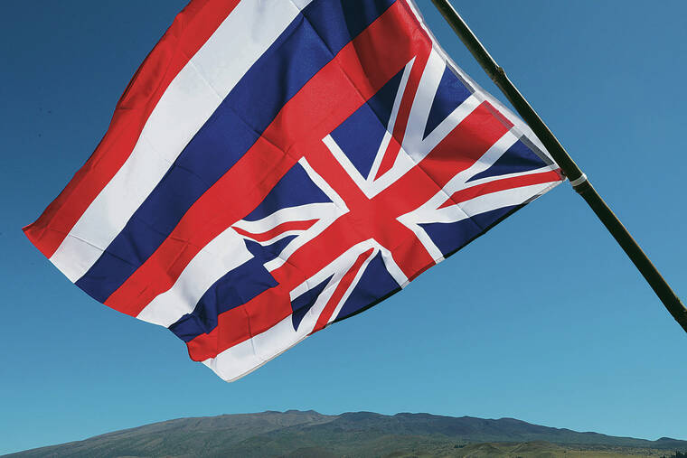 JAMM AQUINO / 2019
                                A Hawaiian flag flies upside down with Mauna Kea in the background during protests against the proposed construction of the Thirty Meter Telescope.