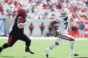 K.C. ALFRED / THE SAN DIEGO UNION-TRIBUNE VIA AP
                                Arizona’s Jayden de Laura rolled out of harm’s way while being pursued by San Diego State’s Jonah Tavai last Saturday in San Diego. De Laura completed 29 of 35 passes for 299 yards and four TDs.