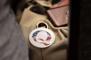 ASSOCIATED PRESS / AUG. 27
                                A QAnon conspiracy theory button sits affixed to the purse of an attendee of the Nebraska Election Integrity Forum last month in Omaha, Neb.