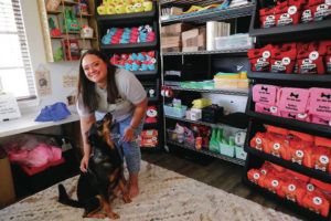 JAMM AQUINO / JAQUINO@STARADVERTISER.COM
                                Leah Lukela, owner of Dis-and-Bark, with “CEO” Rollo — Lukela’s Rottweiler/German shepherd mix — in the showroom of her Ewa Beach residence in August. Lukela’s small business has expanded since its inception in 2021, with a unique line of distinctly local dog toys and accessories.