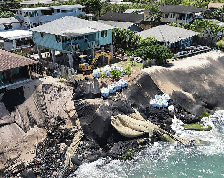 COURTESY DLNR
                                Drone footage shows machinery at the North Shore property at 59-181-D Ke Nui Road with large materials, some of which have rolled down the shore, in an effort to save the home against erosion.
