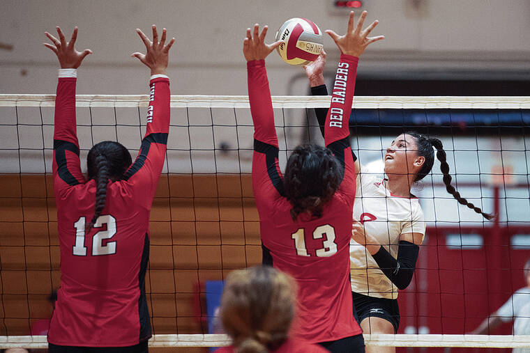 GEORGE F. LEE / GLEE@STARADVERTISER.COM
                                Kalani’s Haylee Lyons tried to hit over Kahuku’s Mao Lauhingoa, left, and Maia Esera during an OIA girls volleyball match at Kalani High gym on Wednesday.