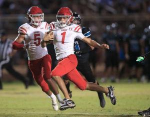 JAMM AQUINO / JAQUINO@STARADVERTISER.COM
                                Kahuku quarterback Waika Crawford finds the end zone for a touchdown against the Kapolei Hurricanes during the first half.