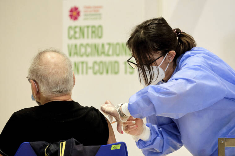 LA PRESSE VIA AP / APRIL 4, 2021 A person receives a COVID-19 vaccination shot campaign in Rome in 2021. COVID cases across the European Union spiked to 1.5 million last week, up 8% from the week prior, official said. Hospitalizations are also up across the 27-nation bloc, with Italy reporting a 32% jump in admissions for the week ending on Oct. 4.