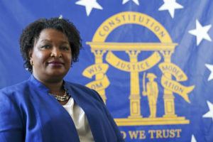 ASSOCIATED PRESS / AUG. 8
                                Democratic candidate for Georgia governor Stacey Abrams poses for a portrait in front of the State Seal of Georgia on Aug. 8, in Decatur, Ga.