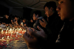 DITA ALANGKARA / AP
                                Soccer fans pray during a candle light vigil for the victims of Saturday’s stampede, in Tangerang, Indonesia, Tuesday, Oct. 4. Police firing tear gas inside a stadium in East Java on Saturday in an attempt to stop violence after an Indonesian soccer match triggered a disastrous crush of fans making a panicked, chaotic run for the exits, leaving at a number of people dead, most of them trampled upon or suffocated.