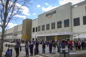 ASSOCIATED PRESS
                                Amazon workers line up outside the company’s facility, in Staten Island borough of New York, March 25. Amazon has suspended at least 50 workers who refused to work their shifts following a trash compactor fire at the warehouse, Tuesday, according to union organizers.
