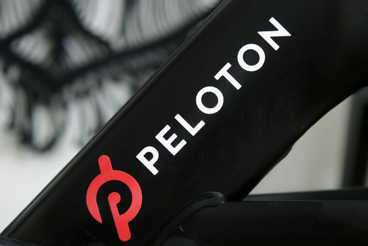 ASSOCIATED PRESS / 2019 A Peloton logo on the companys stationary bicycle in San Francisco, Calif. Peloton told employees that it will cut approximately 500 jobs, or about 12% of its workforce, as post-pandemic sales of its indoor exercise equipment continue to tail off.