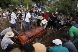 EDUARDO VERDUGO / AP
                                Residents bury Wilmer Rojas the day after he was killed in a mass shooting in San Miguel Totolapan, Mexico, Thursday, Oct. 6. Gunmen burst into a town hall meeting and shot to death 20 people, including a mayor and his father, officials said Thursday.