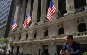 ASSOCIATED PRESS
                                A trader stands outside the New York Stock Exchange, Sept. 23, in New York.