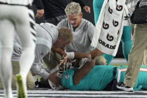 ASSOCIATED PRESS
                                Miami Dolphins quarterback Tua Tagovailoa is examined during the first half on Thursday.