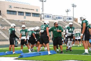 STEVEN ERLER / SPECIAL TO THE HONOLULU STAR-ADVERTISER
                                Hawaii Warriors defensive line coach Eti Ena during a University of Hawaii Fall football camp practice at Ching Field.