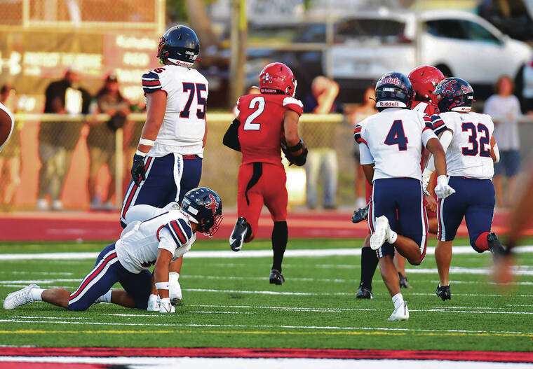 STEVEN ERLER / SPECIAL TO THE STAR-ADVERTISER
                                Kahuku defensive back Kaimana Carvalho intercepted the ball and returned it for a touchdown during the first half.