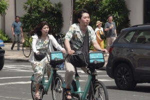 CRAIG T. KOJIMA / CKOJIMA@STARADVERTISER.COM
                                Above, Japanese visitors rode bicycles Monday on Kala­kaua Avenue.