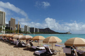 CINDY ELLEN RUSSELL / FEB. 26
                                This year the state Department of Business, Economic Development and Tourism expects visitor arrivals to reach 9.8 million, which is 5% below the peak 10.3 million out-of-state visitors that came to Hawaii in 2019. Loungers and umbrellas line the beach in Waikiki.